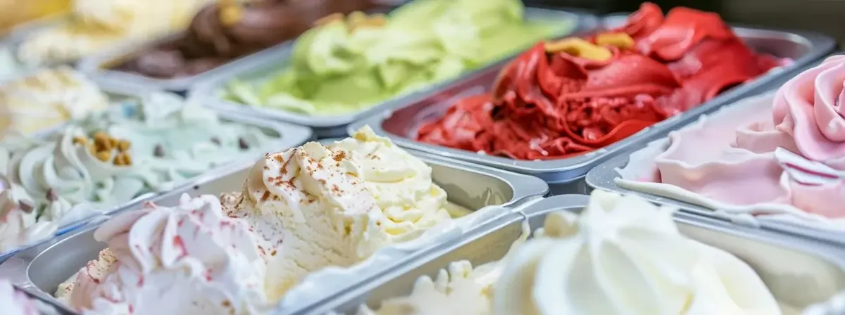 Gelato fresco e variegato in gelateria, rappresentazione dell'eccellenza italiana che alimenta il mercato delle basi negli USA